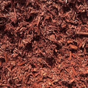 Close-up of shredded red mulch covering the ground.