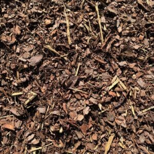 Close-up of dark brown mulch with wood chips and bark pieces.