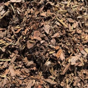 Close-up of shredded brown mulch on the ground.